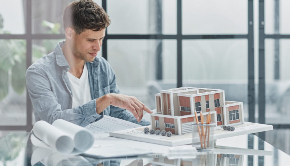 male architect designer examines the layout of the house. new project