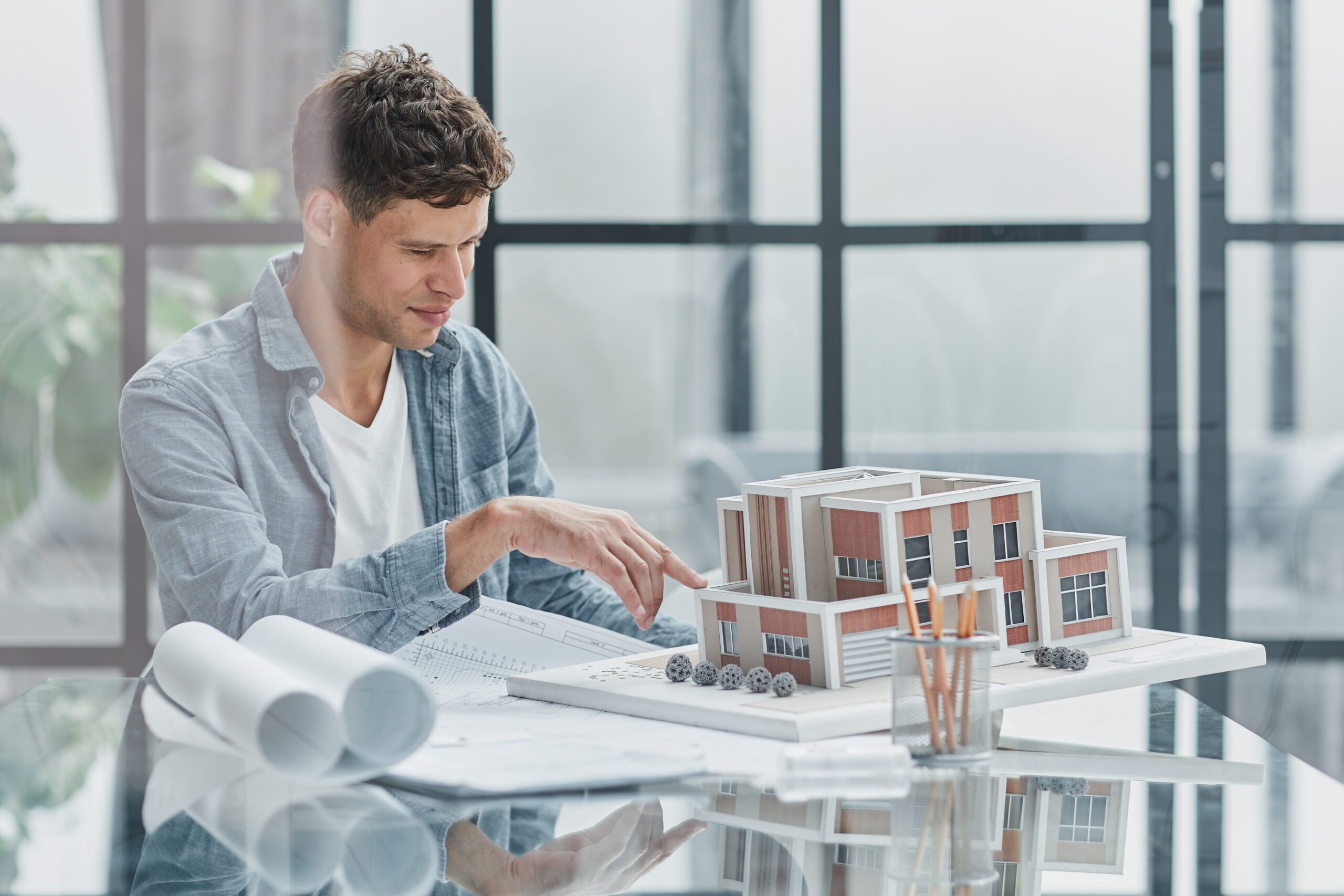 male architect designer examines the layout of the house. new project